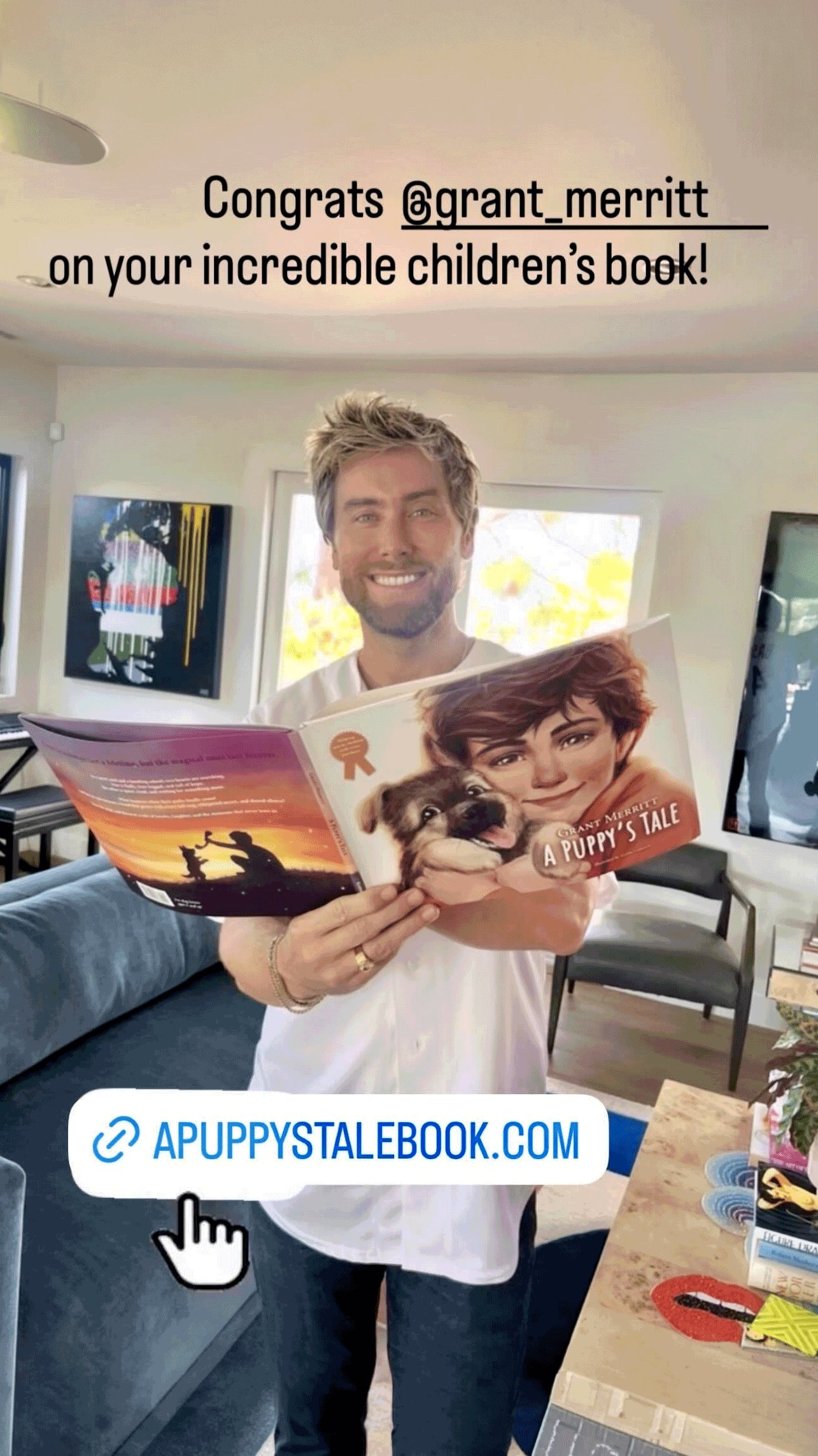 Lance Bass holding A Puppy's Tale children's book by Grant Merritt
